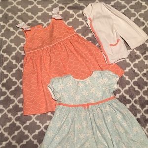 Two dresses with matching sweater.